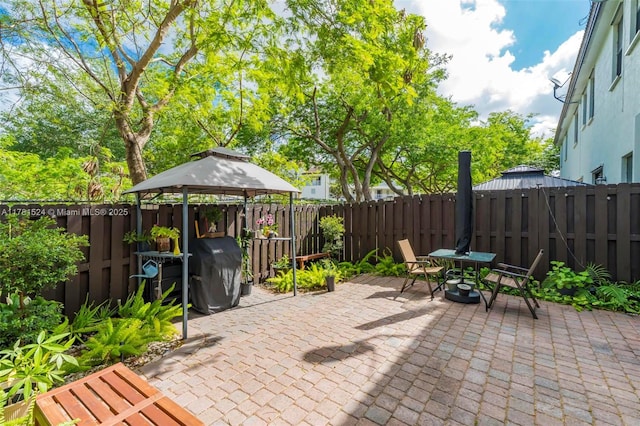 view of patio with a fenced backyard and a gazebo