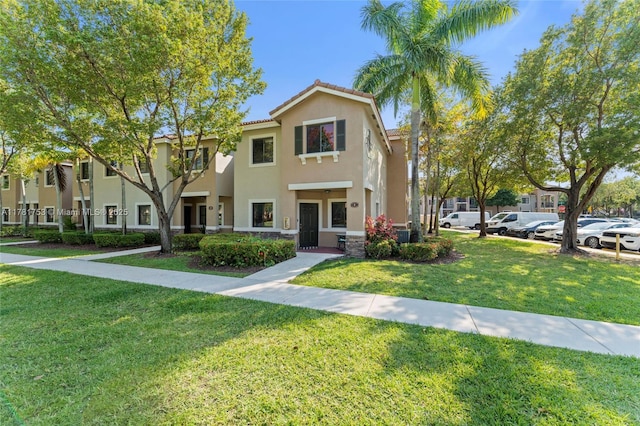 view of front of property featuring a front yard and stucco siding