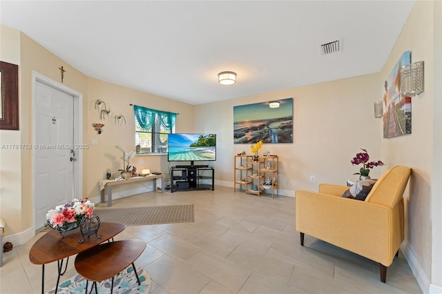 living room featuring visible vents, baseboards, and light tile patterned floors