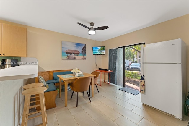 dining room featuring a ceiling fan and light tile patterned floors