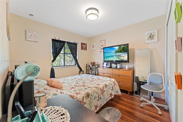 bedroom with dark wood finished floors