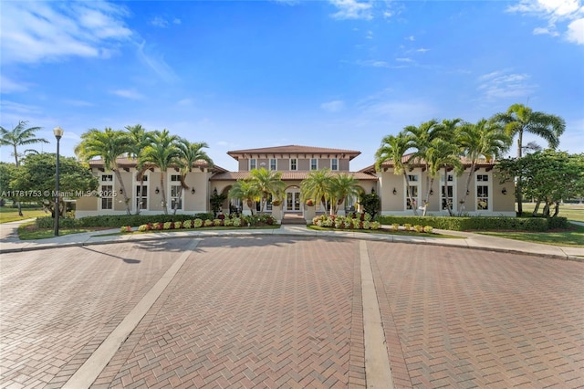 mediterranean / spanish house with french doors and stucco siding