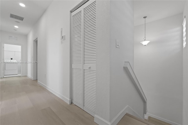 hall featuring visible vents, baseboards, washer / dryer, and recessed lighting