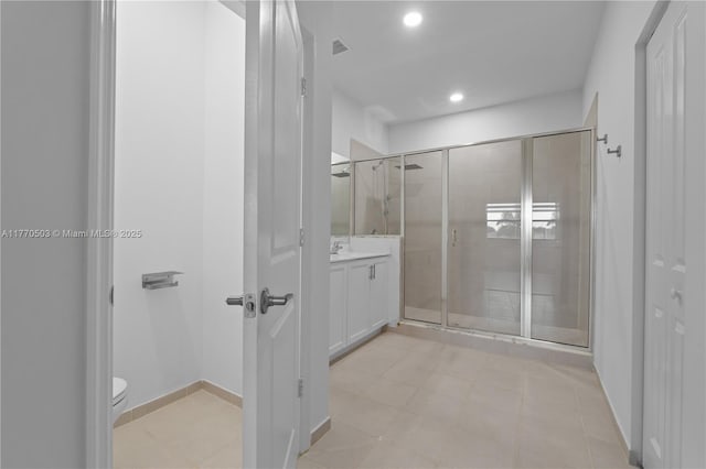 bathroom with visible vents, toilet, a shower stall, recessed lighting, and vanity