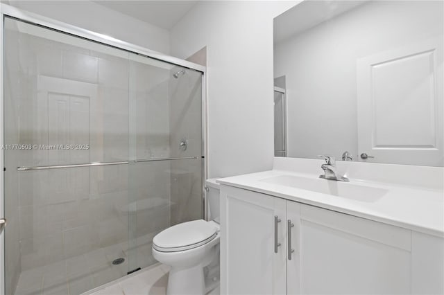 full bathroom with vanity, a stall shower, and toilet