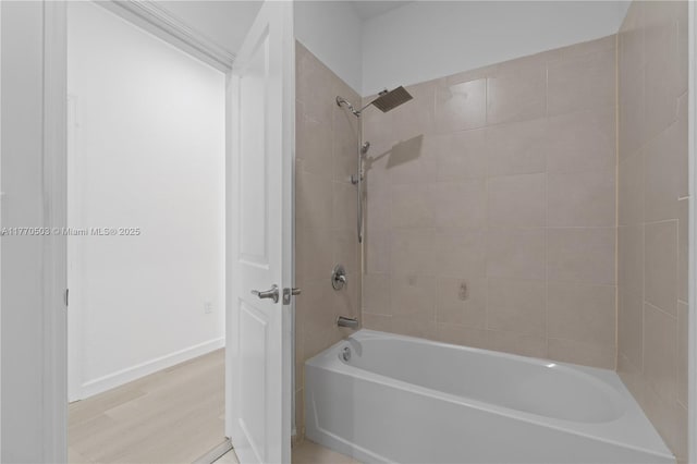 full bath featuring bathtub / shower combination, wood finished floors, and baseboards