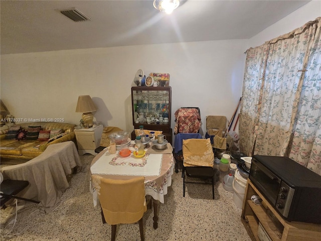 interior space with visible vents and light speckled floor
