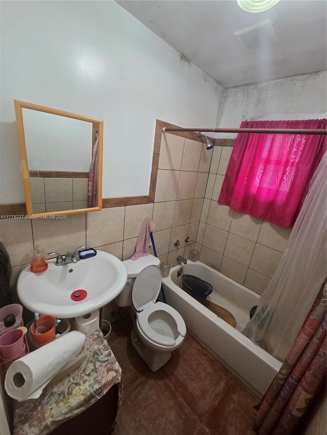 full bath with shower / bath combination with curtain, toilet, visible vents, tile walls, and a sink