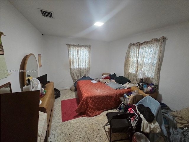bedroom with visible vents and speckled floor