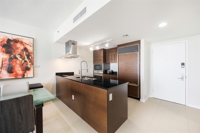 485 Brickell Ave Unit 4707, Miami, FL 33131 - kitchen with a sink, built in appliances, a peninsula, island exhaust hood, and visible vents