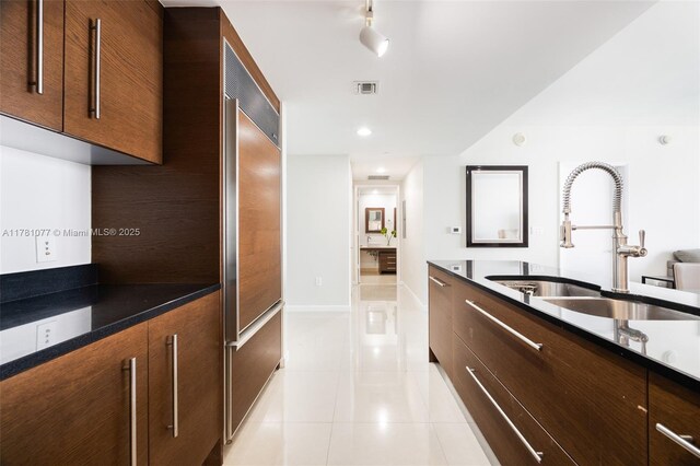 485 Brickell Ave Unit 4707, Miami, FL 33131 - kitchen with visible vents, modern cabinets, built in refrigerator, a sink, and light tile patterned floors