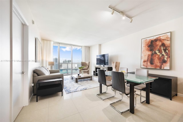 485 Brickell Ave Unit 4707, Miami, FL 33131 - dining space featuring light tile patterned flooring, rail lighting, and a wall of windows