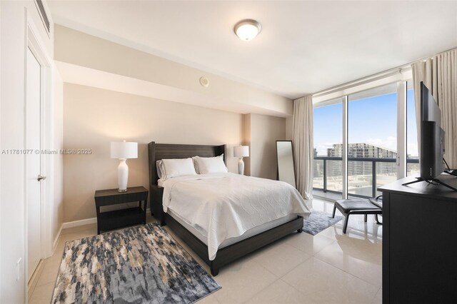485 Brickell Ave Unit 4707, Miami, FL 33131 - bedroom featuring access to outside, baseboards, light tile patterned floors, and a wall of windows