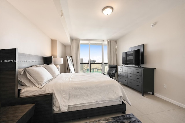485 Brickell Ave Unit 4707, Miami, FL 33131 - bedroom with light tile patterned floors, baseboards, and floor to ceiling windows