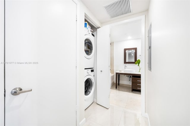 485 Brickell Ave Unit 4707, Miami, FL 33131 - clothes washing area with laundry area, stacked washer / dryer, visible vents, a sink, and light tile patterned flooring