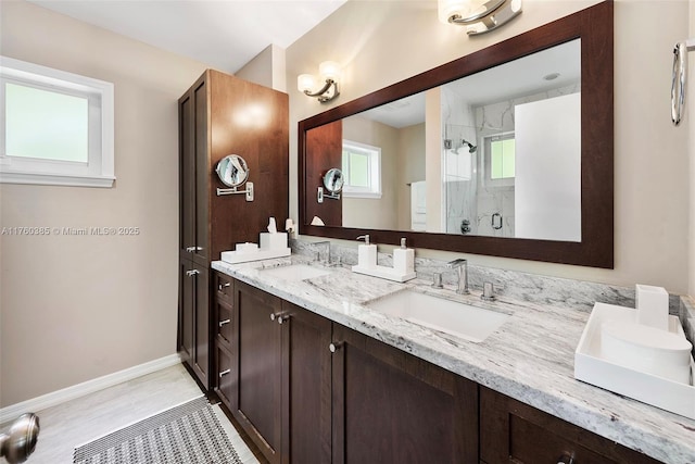 1414 Ferdinand St, Coral Gables, FL 33134 - bathroom featuring a sink, baseboards, double vanity, and a stall shower