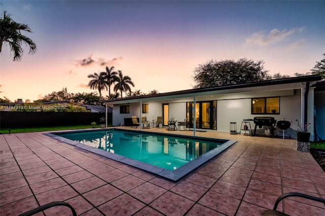 8360 SW 148th Dr, Palmetto Bay, FL 33158 - pool at dusk with a patio area and a fenced in pool