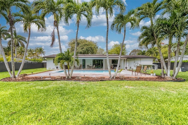 8360 SW 148th Dr, Palmetto Bay, FL 33158 - back of house with a fenced in pool, a patio, stucco siding, fence, and a lawn