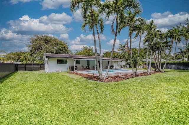 8360 SW 148th Dr, Palmetto Bay, FL 33158 - back of house with a yard, a fenced backyard, a fenced in pool, and stucco siding