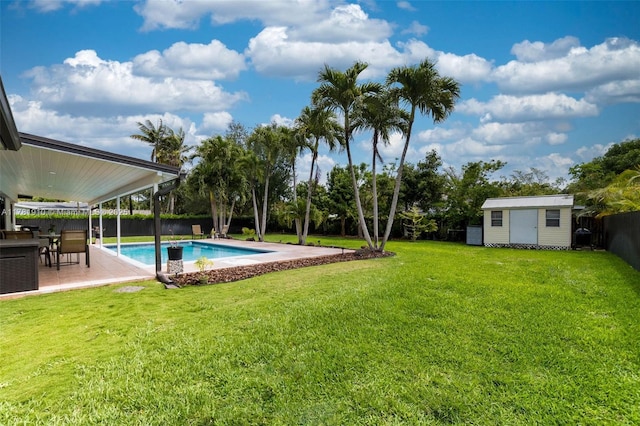 8360 SW 148th Dr, Palmetto Bay, FL 33158 - view of pool with a patio area, a lawn, a fenced backyard, a storage unit, and an outbuilding