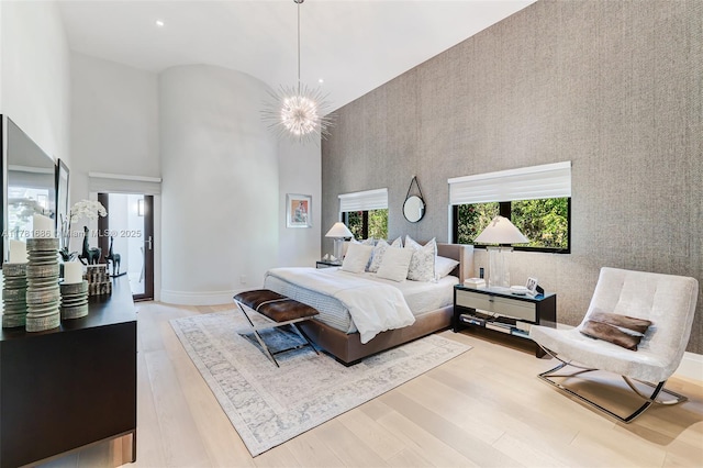 555 Arvida Pkwy, Coral Gables, FL 33156 - bedroom with wood finished floors, a notable chandelier, and a towering ceiling