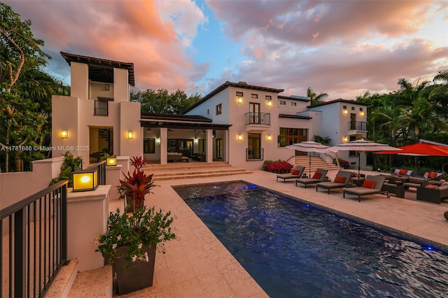 555 Arvida Pkwy, Coral Gables, FL 33156 - rear view of property featuring a patio area, an outdoor pool, a balcony, and stucco siding