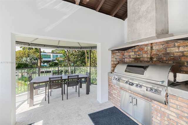 555 Arvida Pkwy, Coral Gables, FL 33156 - view of patio with area for grilling, outdoor dining space, and an outdoor kitchen