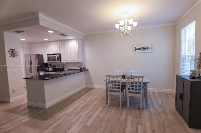 266 Iris Dr, Jupiter, FL 33458 - kitchen featuring an inviting chandelier, dark countertops, ornamental molding, and stainless steel appliances