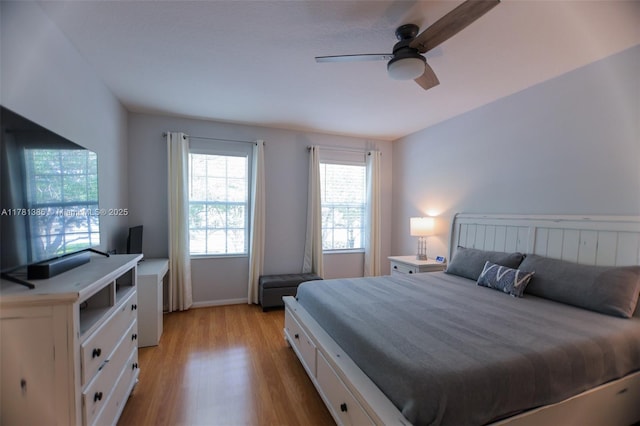 266 Iris Dr, Jupiter, FL 33458 - bedroom with baseboards, a ceiling fan, and light wood-style floors