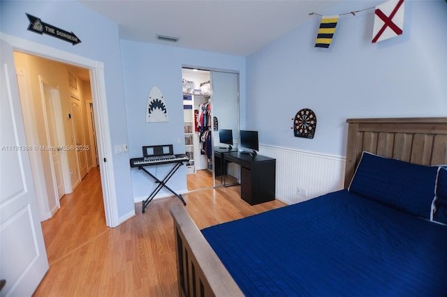 266 Iris Dr, Jupiter, FL 33458 - bedroom with light wood-style floors, a closet, visible vents, and a wainscoted wall
