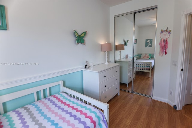 266 Iris Dr, Jupiter, FL 33458 - bedroom with wood finished floors, a closet, and baseboards