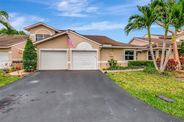 1237 NW 52nd Way, Deerfield Beach, FL 33442 - view of front of property with a garage, a front yard, driveway, and stucco siding