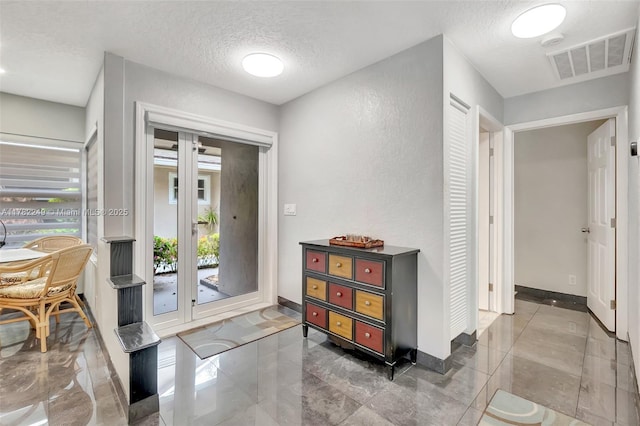 1237 NW 52nd Way, Deerfield Beach, FL 33442 - entrance foyer with baseboards, a textured wall, a textured ceiling, visible vents, and marble finish floor