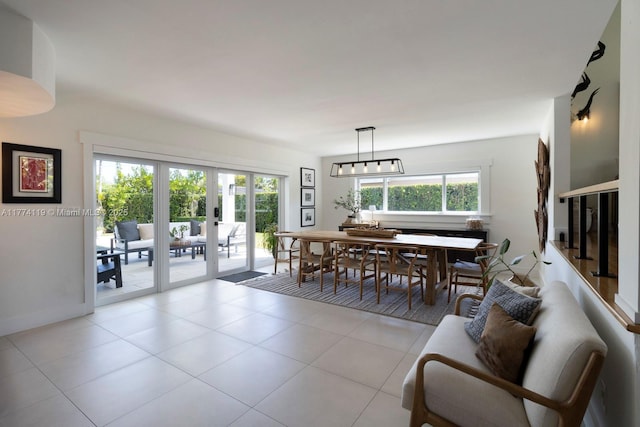 dining room with french doors and light tile patterned flooring