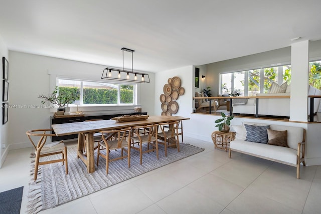 tiled dining area featuring baseboards