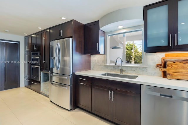 kitchen featuring a sink, light countertops, appliances with stainless steel finishes, recessed lighting, and decorative backsplash