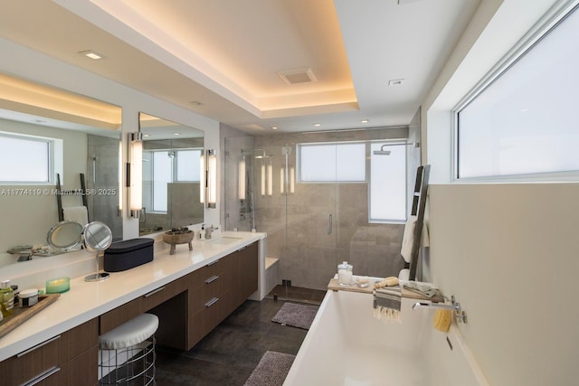 bathroom featuring a shower stall, a healthy amount of sunlight, vanity, and visible vents