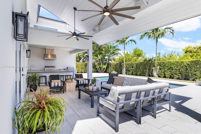 view of patio with a sink, outdoor lounge area, exterior kitchen, and a fenced in pool