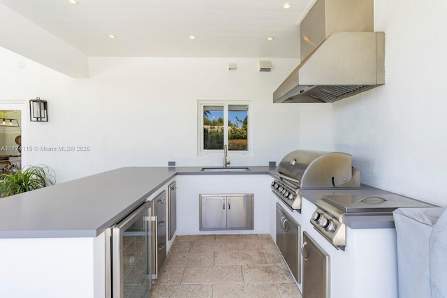 view of patio / terrace with a grill, wine cooler, an outdoor kitchen, and a sink