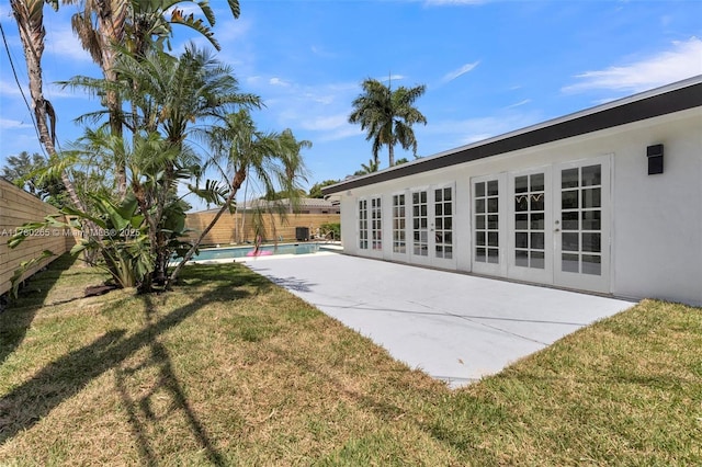 2272 NE 31st St, Lighthouse Point, FL 33064 - fenced backyard featuring french doors and a patio