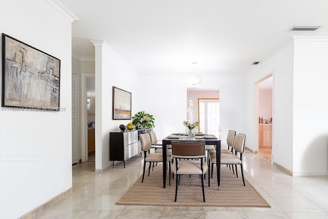 dining space with ornamental molding, baseboards, and light marble finish flooring