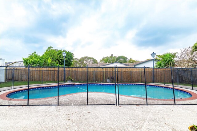 view of swimming pool with a fenced backyard and a patio area