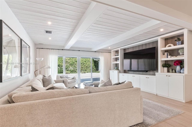 living area featuring visible vents, light wood-style flooring, recessed lighting, and beam ceiling