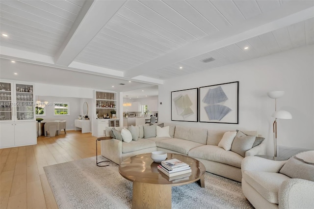living room featuring beamed ceiling, light wood-type flooring, recessed lighting, and wood ceiling