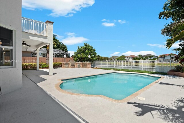 16477 SW 67th Ter, Miami, FL 33193 - view of swimming pool featuring a patio area, exterior kitchen, and a fenced backyard