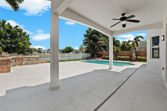 16477 SW 67th Ter, Miami, FL 33193 - view of swimming pool with ceiling fan, a patio, a fenced backyard, and exterior kitchen