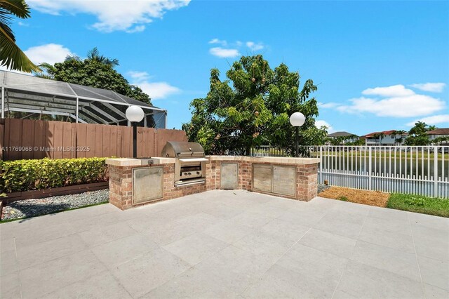 16477 SW 67th Ter, Miami, FL 33193 - view of patio featuring a grill, area for grilling, a water view, and a fenced backyard