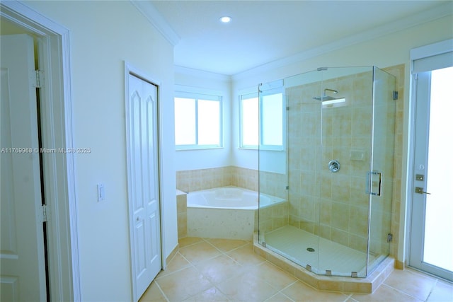 bathroom with tile patterned floors, a shower stall, a bath, and ornamental molding