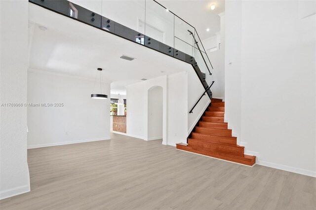 16477 SW 67th Ter, Miami, FL 33193 - stairway featuring wood finished floors, baseboards, and a towering ceiling