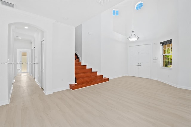 16477 SW 67th Ter, Miami, FL 33193 - foyer with light wood-style floors, arched walkways, baseboards, stairs, and crown molding